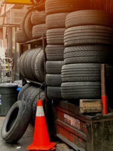Close-up of a technician reading numbers and symbols on a commercial tire sidewall.
